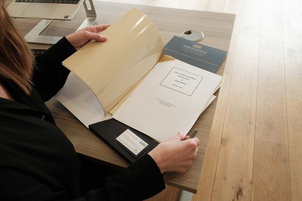 A Kingswood adviser checking and verifying a signed will