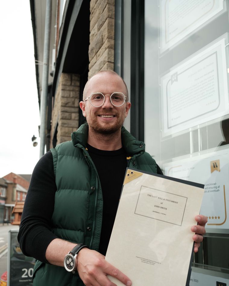 A Kingswood adviser holding completed legal documents outside the Anstey office
